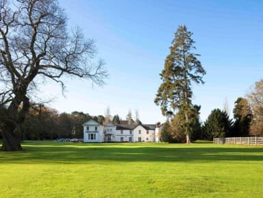 White Georgian country house hotel set within expansive lawns and mature trees.