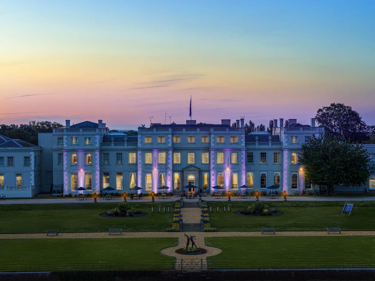 De Vere Wokefield Estate Georgian manor exterior lit up at dusk with manicured lawns