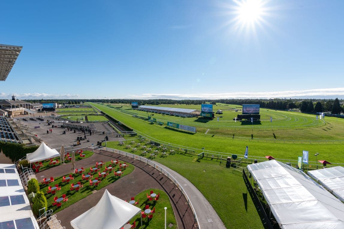 Aerial view of Doncaster Racecourse showing the track, grandstand and outdoor seating areas.