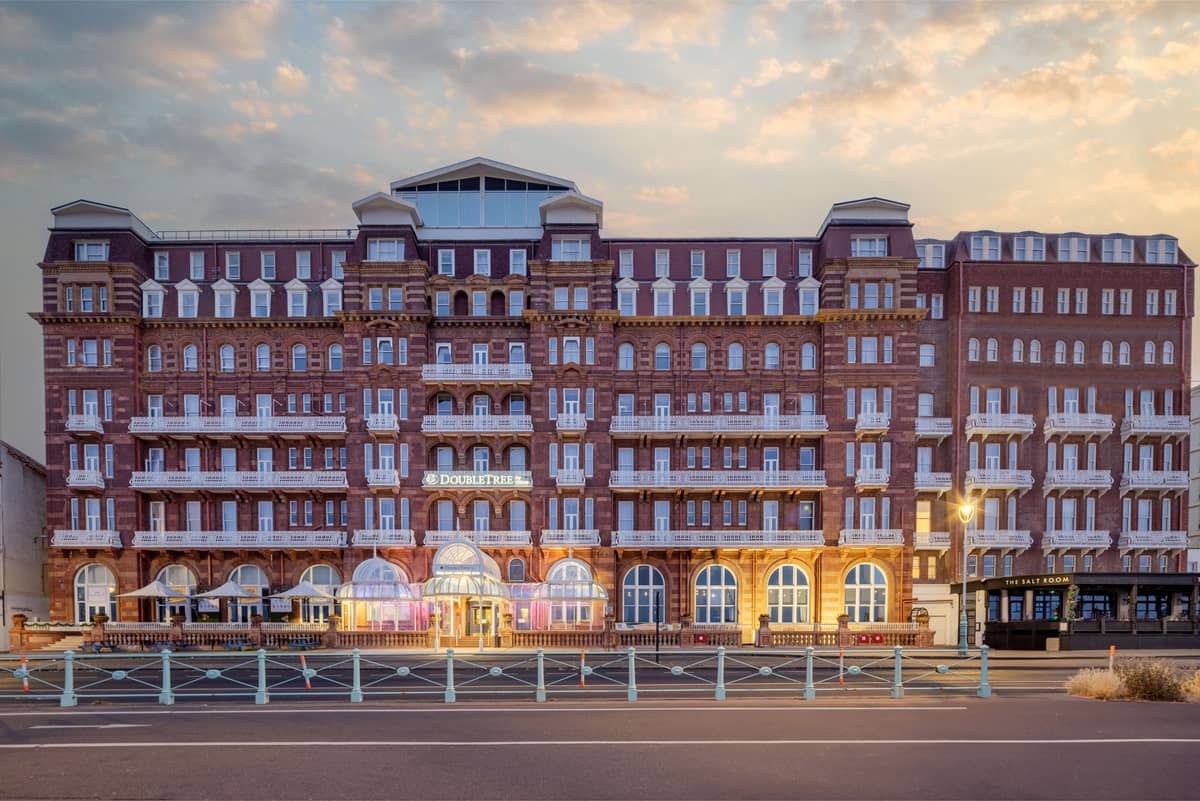 Exterior of the DoubleTree by Hilton Brighton Metropole at dusk on the seafront