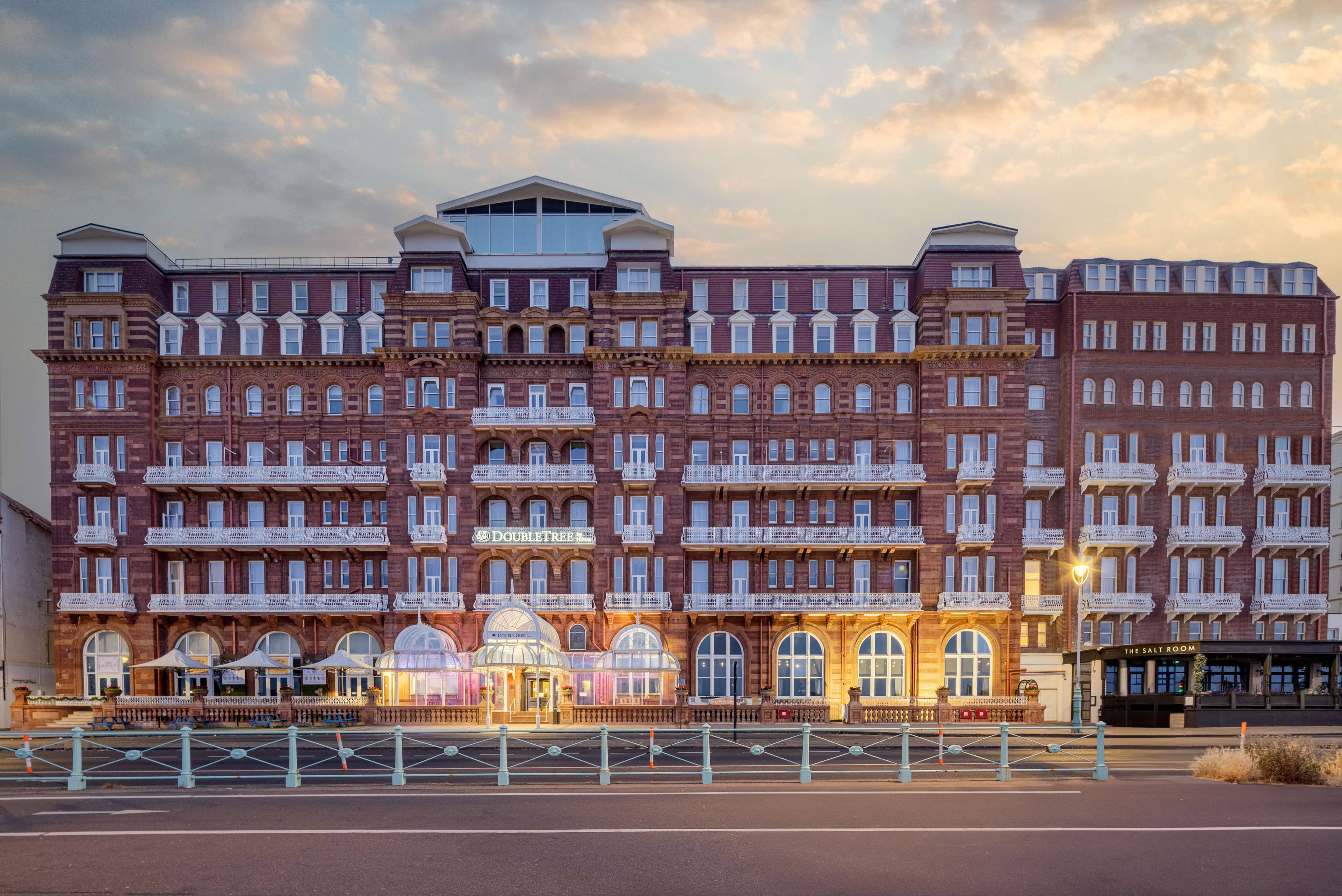Exterior of the DoubleTree by Hilton Brighton Metropole at dusk on the seafront