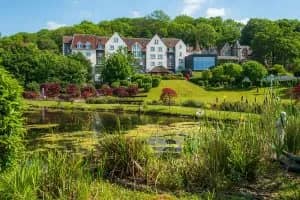 Doubletree by Hilton Cadbury House exterior with ornamental pond and lush gardens