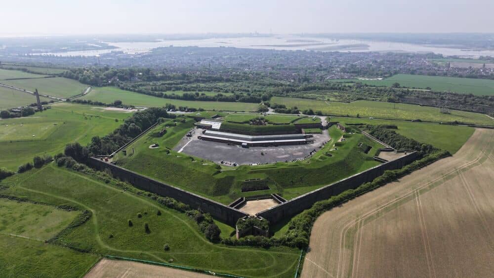 Aerial view of Fort Nelson's star-shaped fortifications surrounded by green fields and the Solent.