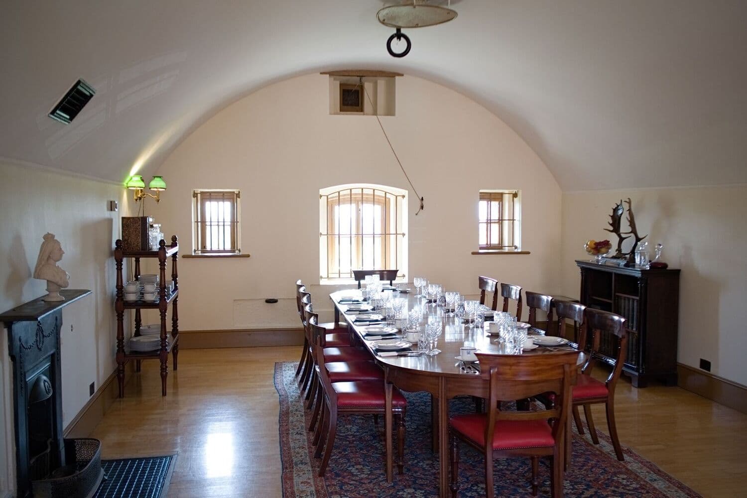 Barrel-vaulted dining room with a long table set for formal dining at Fort Nelson.