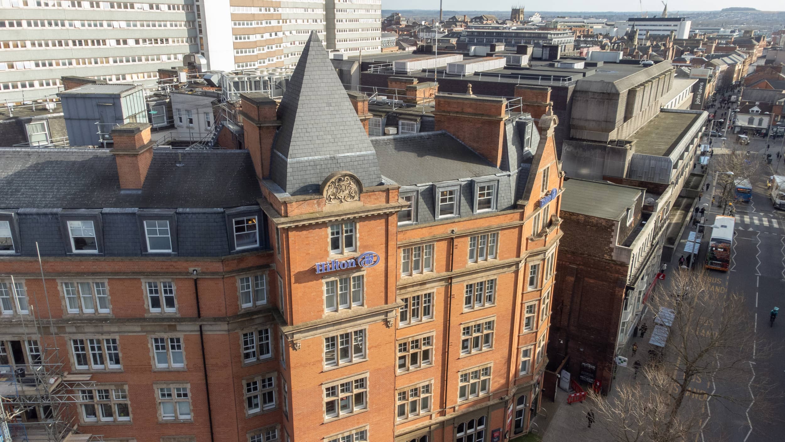 Aerial view of the Hilton Nottingham red brick building on a city centre street.