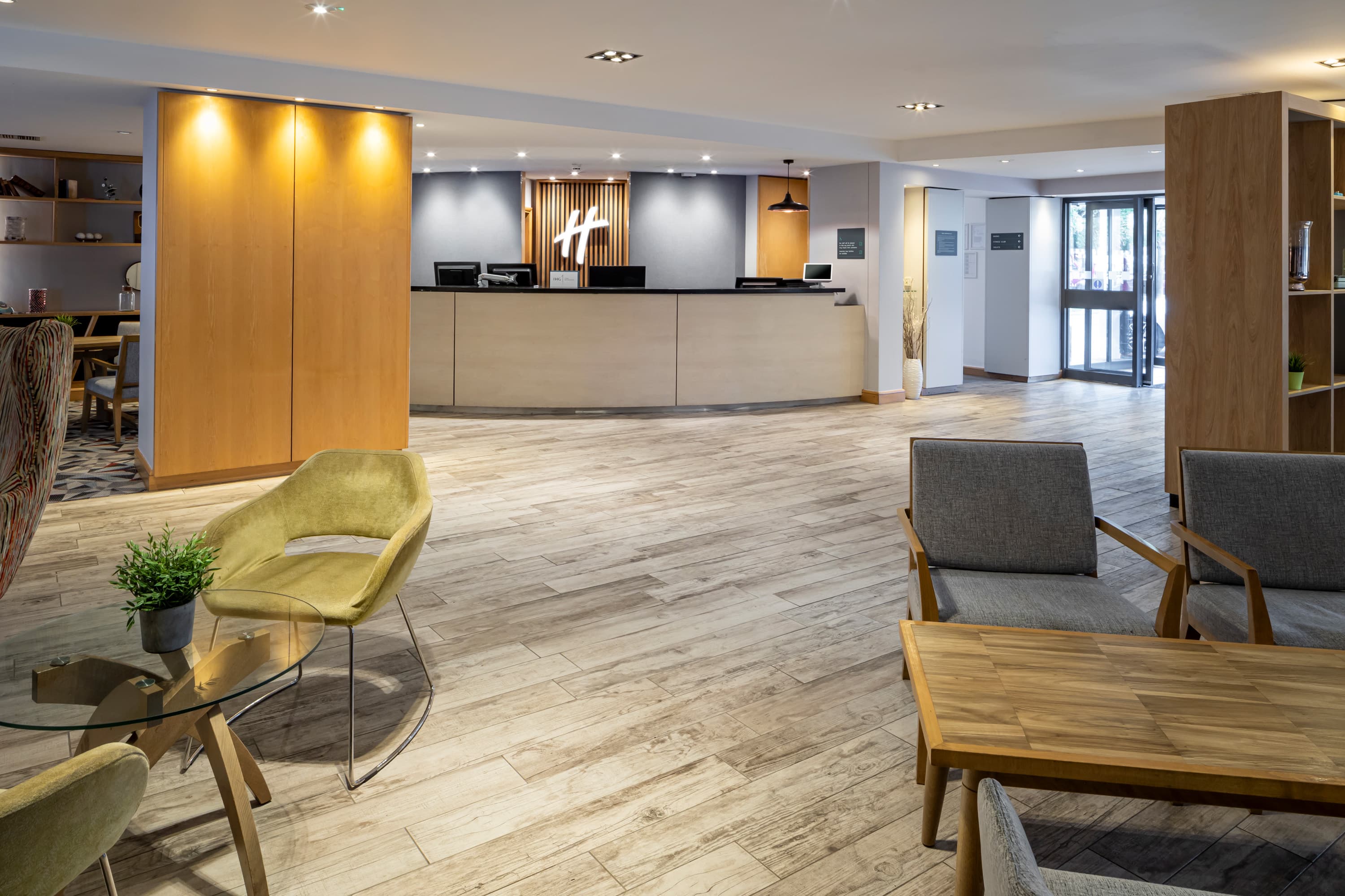 Hotel lobby at Holiday Inn Reading South with reception desk and seating area.