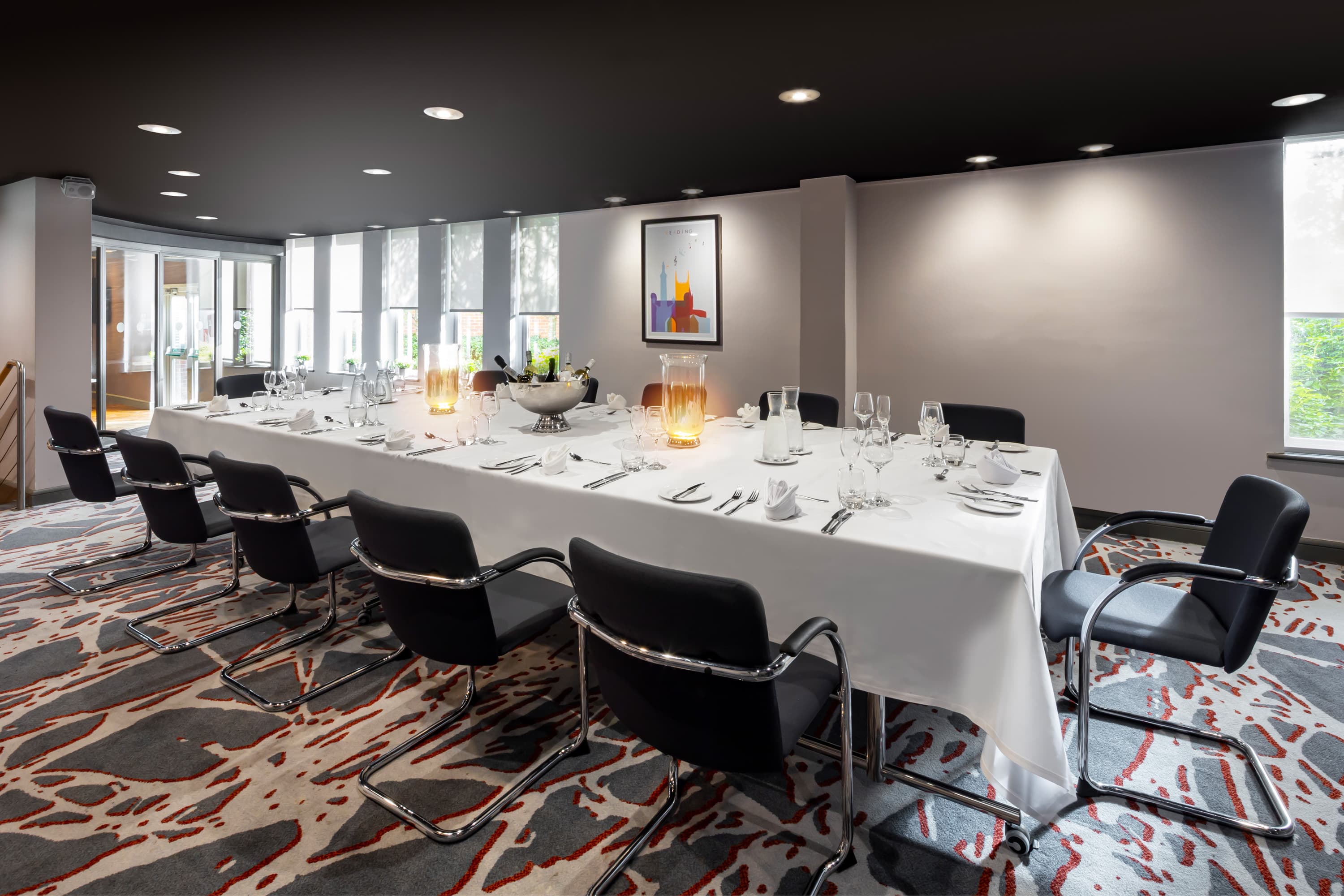Private dining room with a long white-clothed table set for a formal meal.