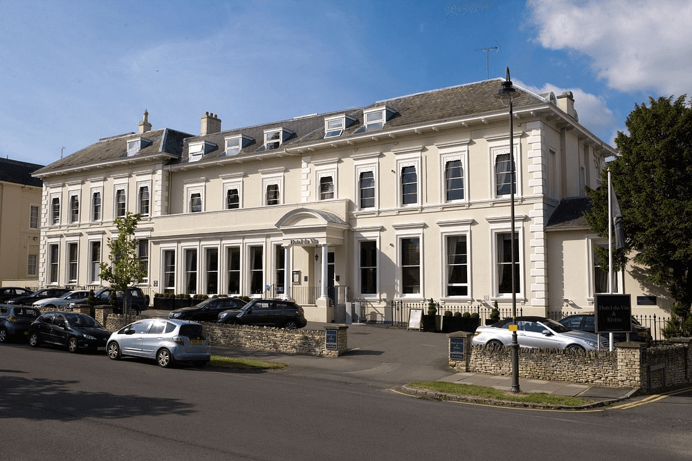 The cream-painted Georgian exterior of Hotel du Vin Cheltenham on a sunny day.