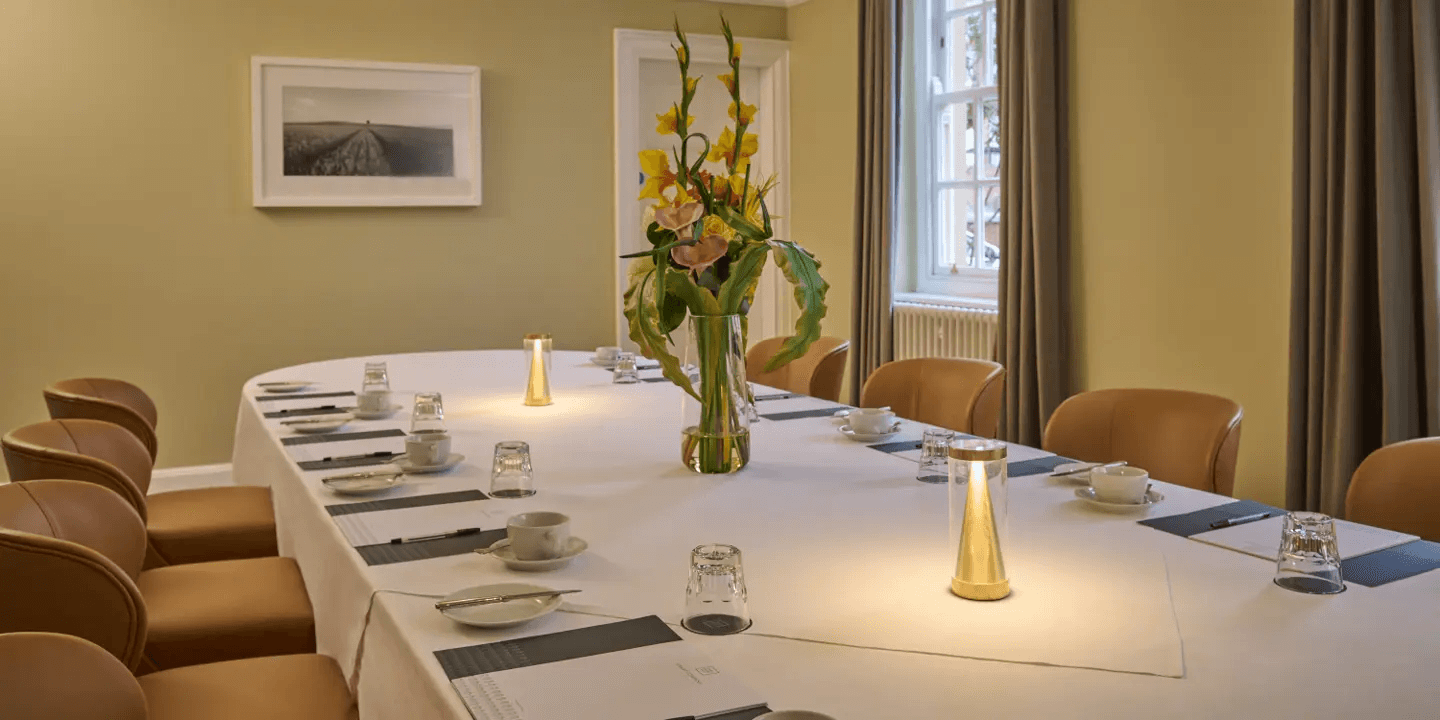 Private dining room at Hotel du Vin Exeter with laid table and floral centrepiece.