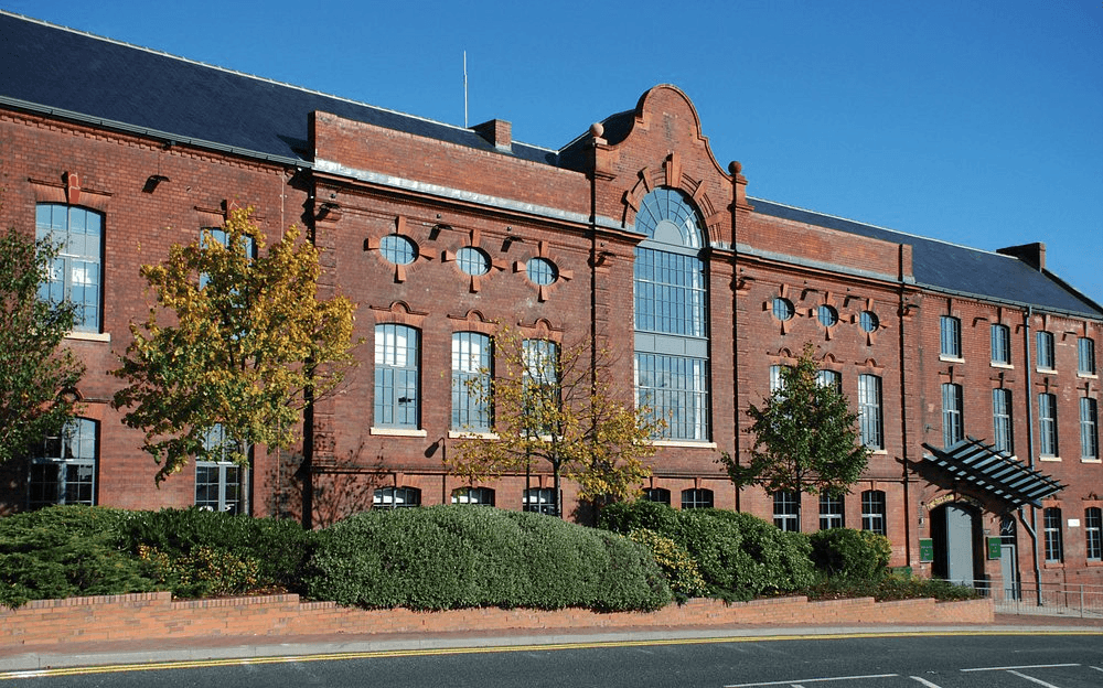 Exterior of Hotel du Vin Newcastle, a large red brick Victorian building with ornate detailing.