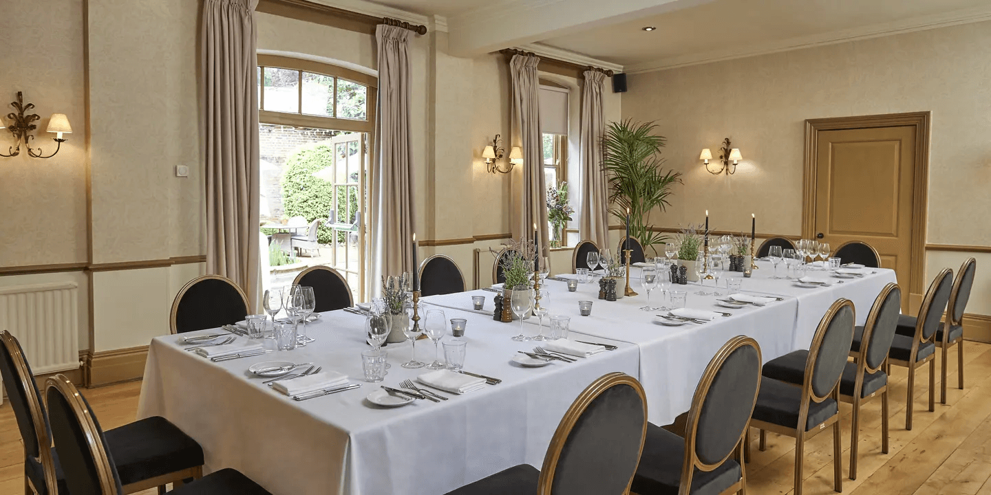 Private dining room at Hotel du Vin Winchester laid for a formal seated meal.