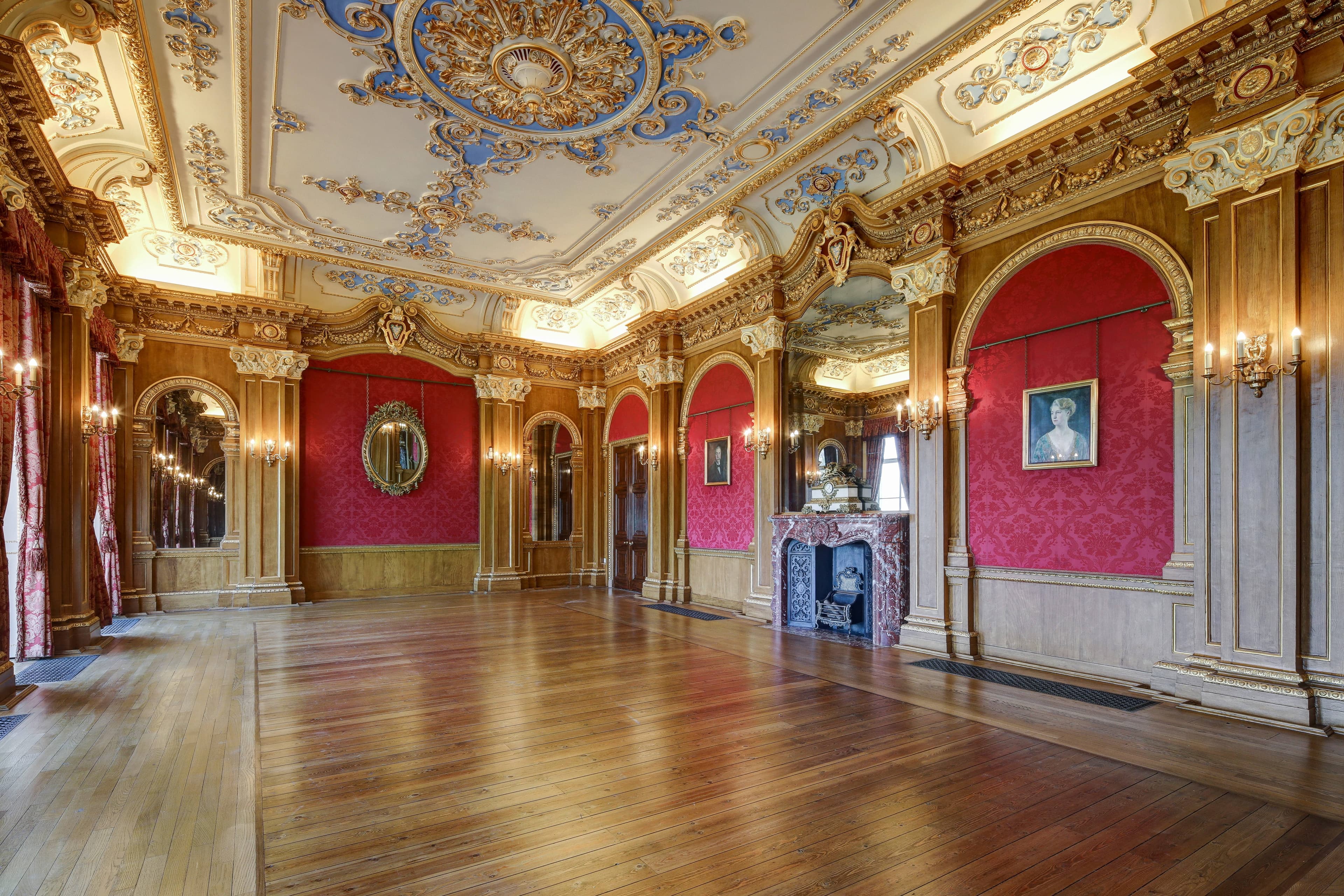 Grand ballroom at Hylands Estate with ornate gilded ceiling, red damask walls and parquet floor.