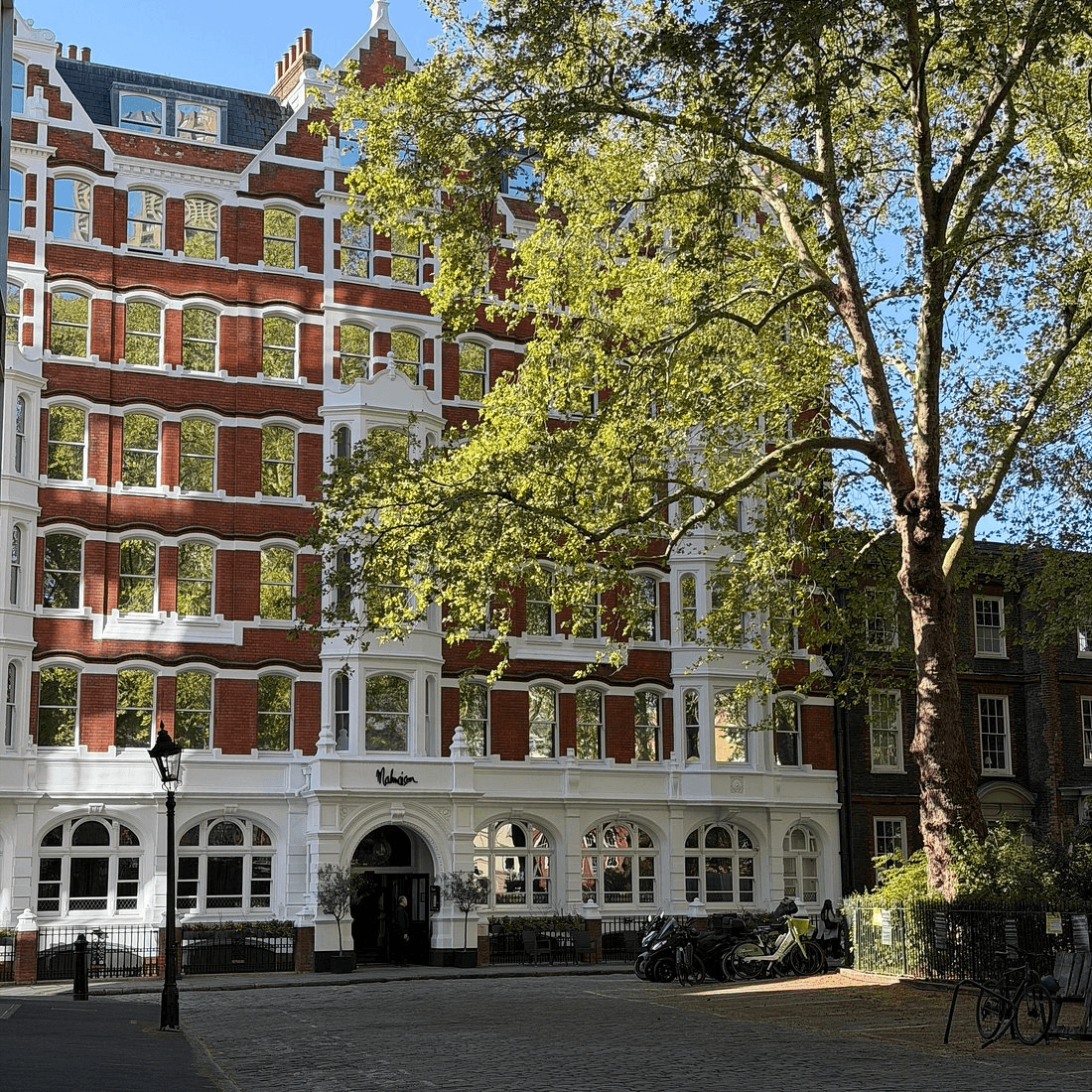 Exterior of Malmaison London, a red brick Victorian building on a cobbled street.