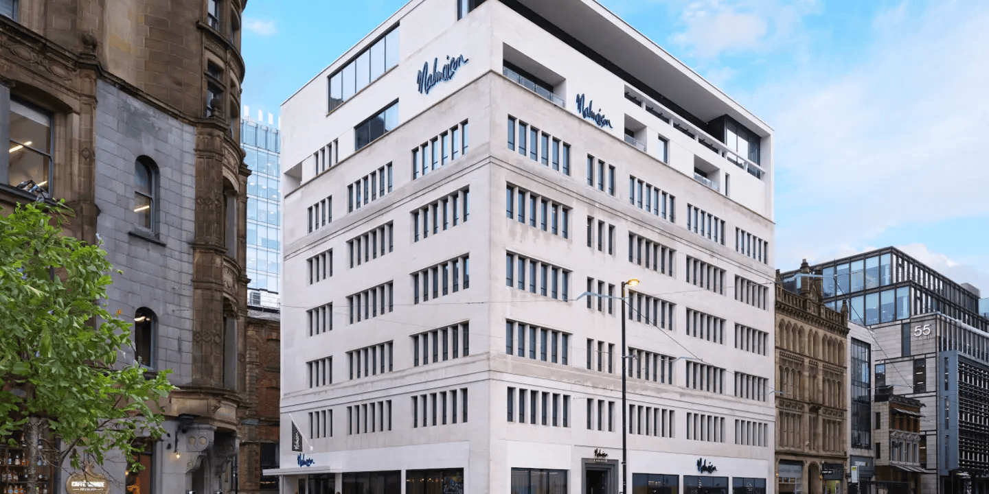 Exterior of Malmaison Manchester Deansgate, a tall white modern hotel building on a city street.