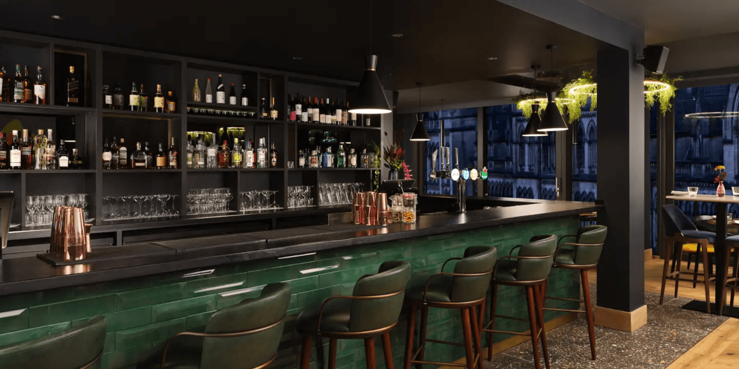 The bar at Malmaison Manchester Deansgate with green tiled front and leather stools.