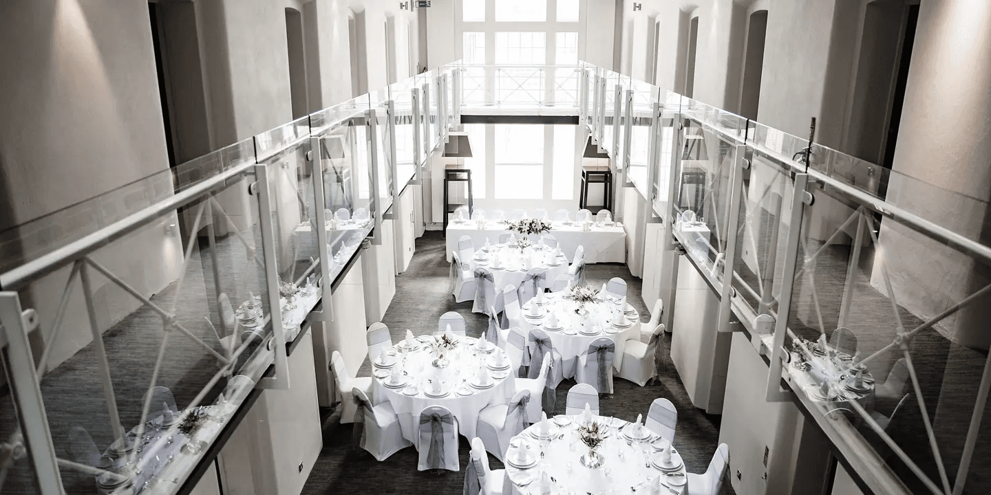 Aerial view of a double-height function room set for a wedding reception at Malmaison Oxford.