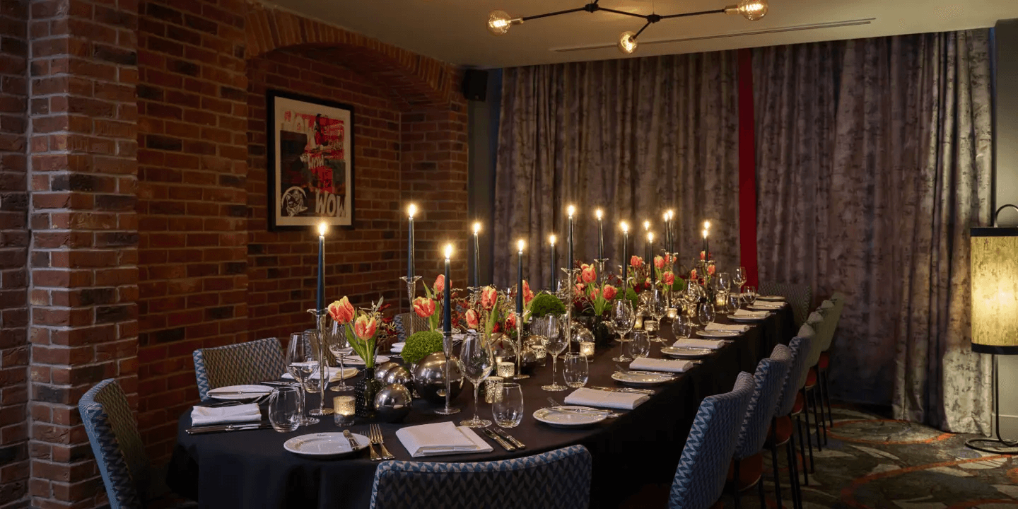 Private dining room at Malmaison Reading with candlelit table and exposed brick walls.