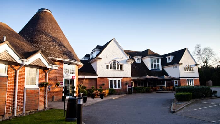 Exterior of Mercure Tunbridge Wells hotel showing an oast house conversion and car park.