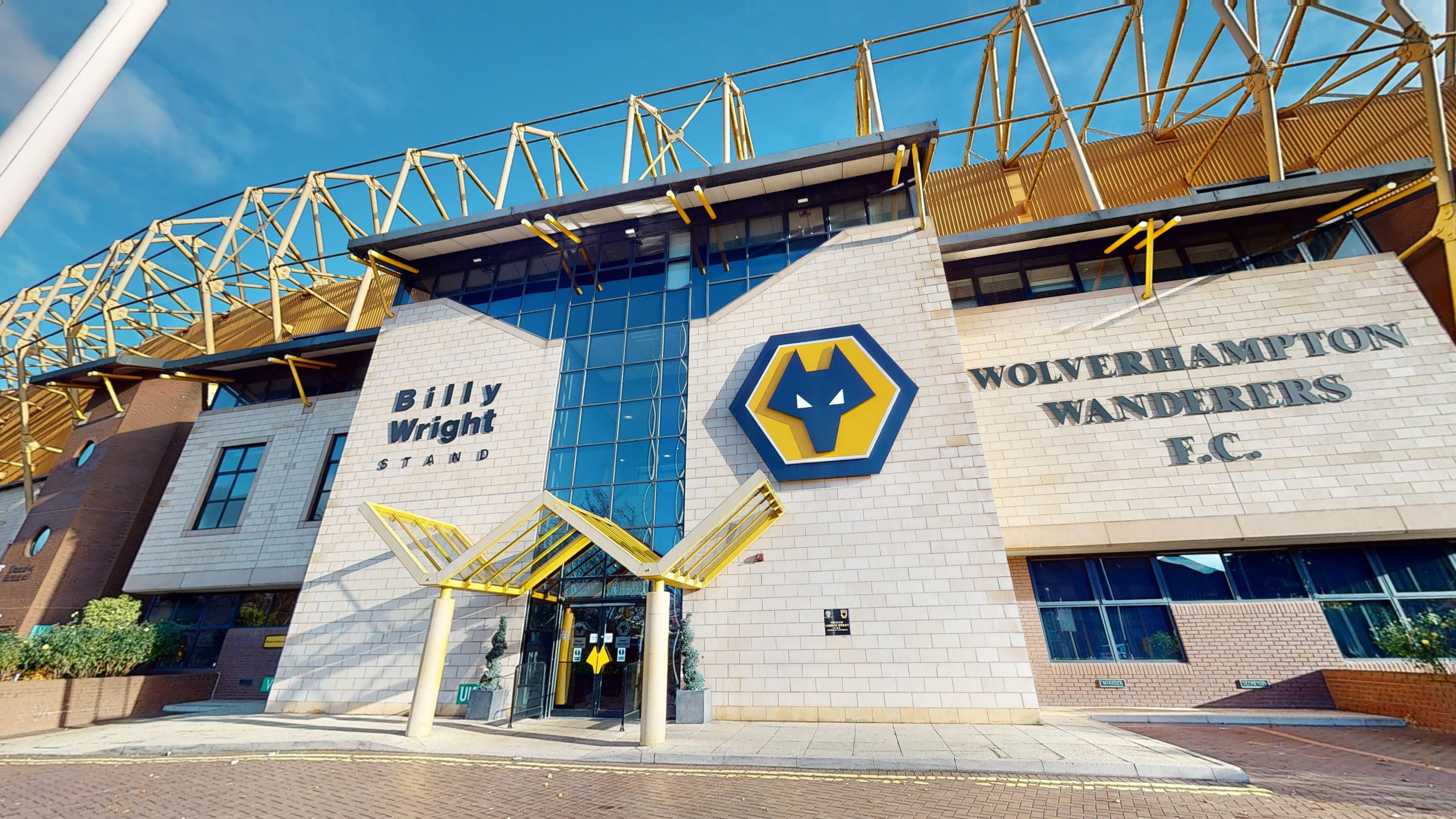 Exterior of Molineux Stadium showing the Billy Wright Stand and Wolves club crest.