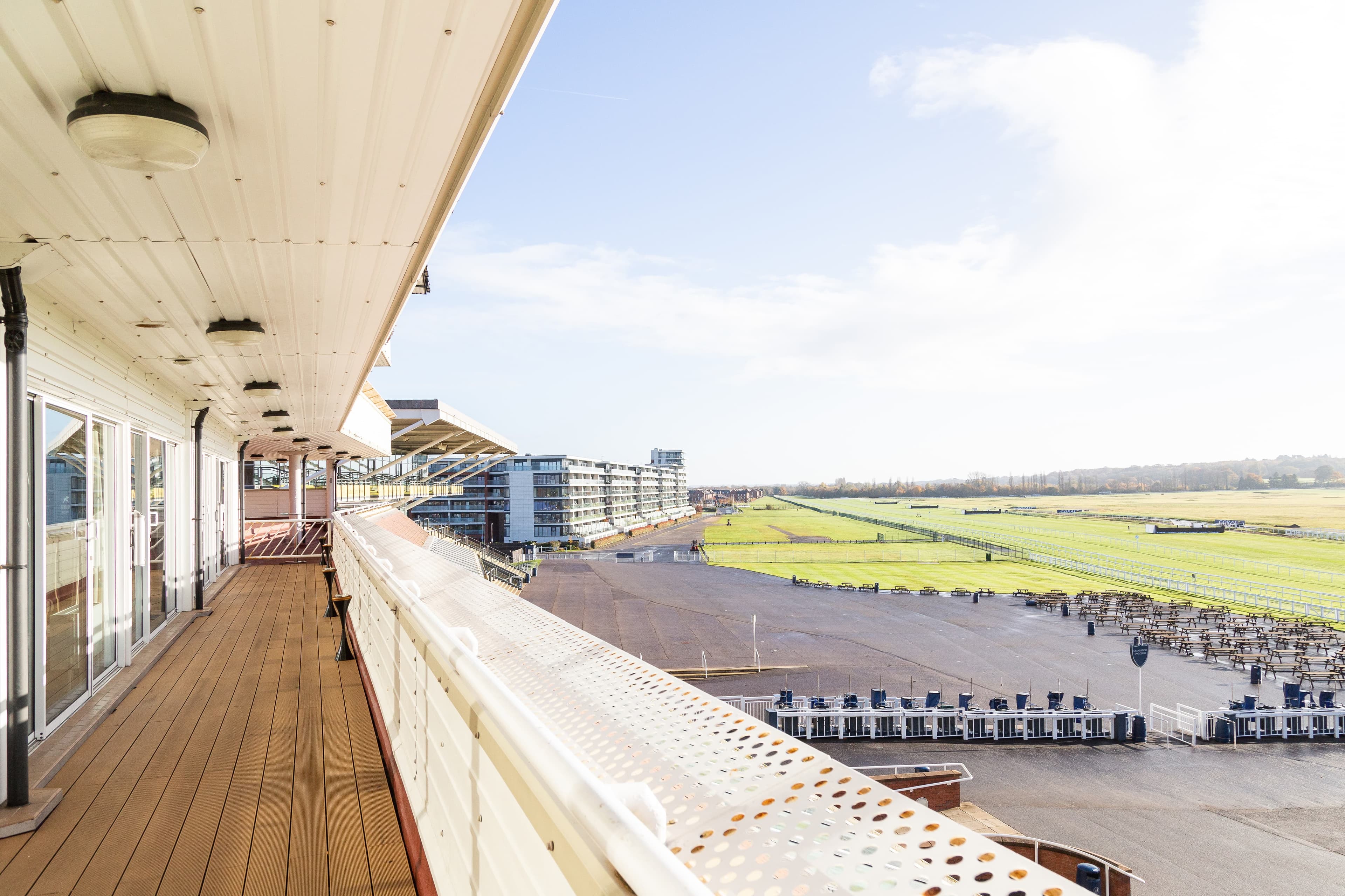 Elevated grandstand terrace overlooking the racecourse track and green turf beyond.