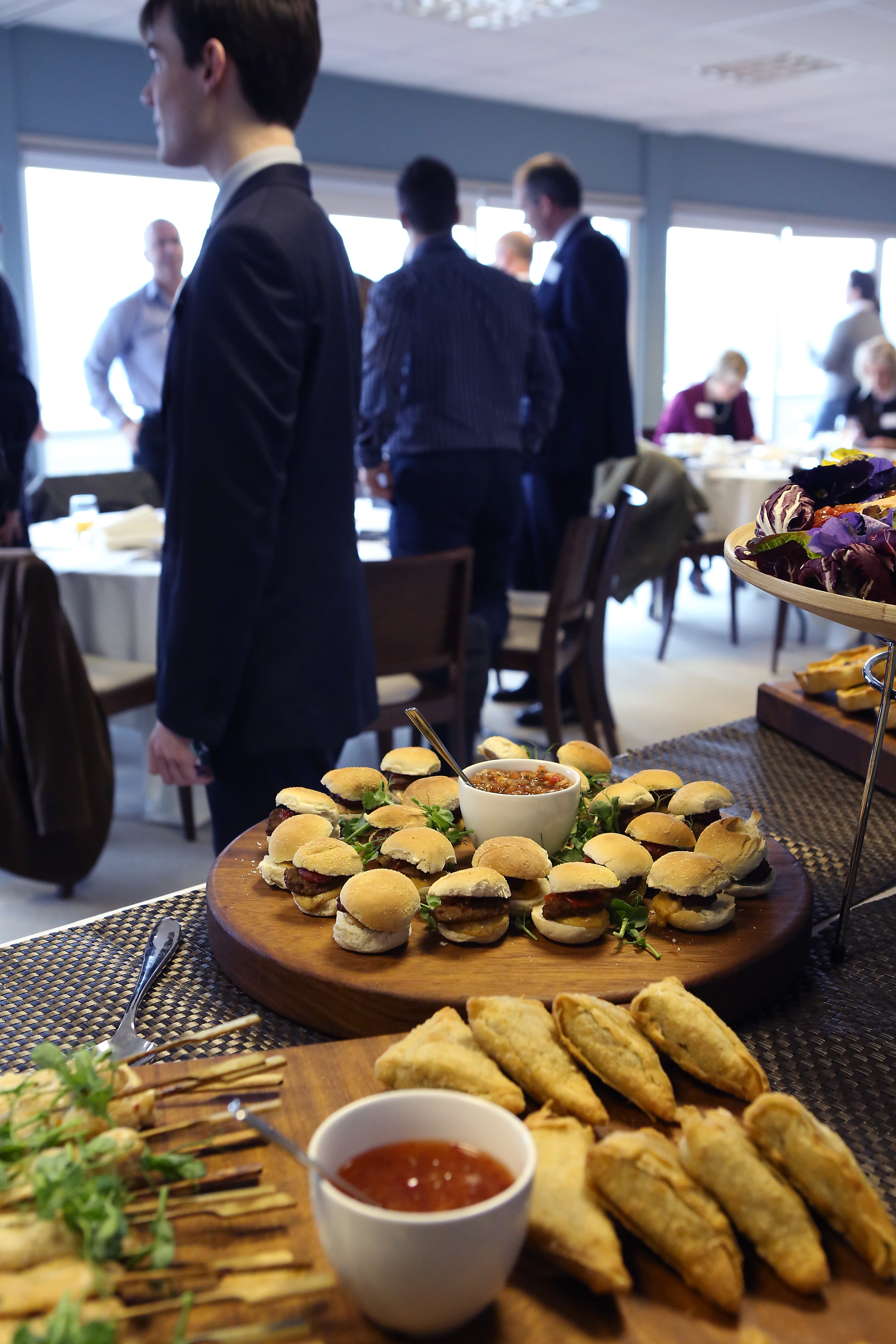 Buffet table of mini sliders and pastries at a Newbury Racecourse function room event.