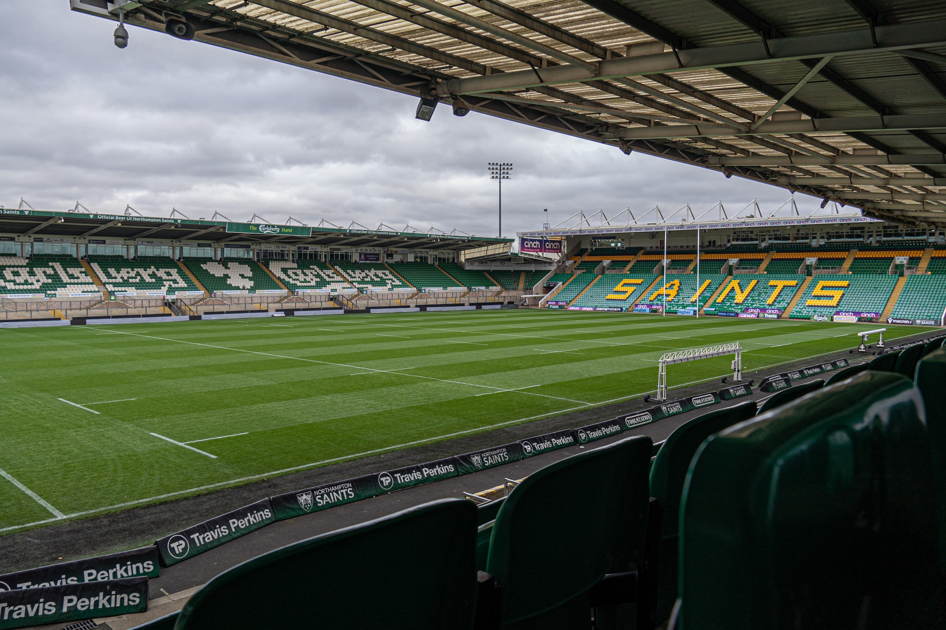 Interior view of cinch Stadium at Franklin's Gardens showing the empty rugby pitch and stands.