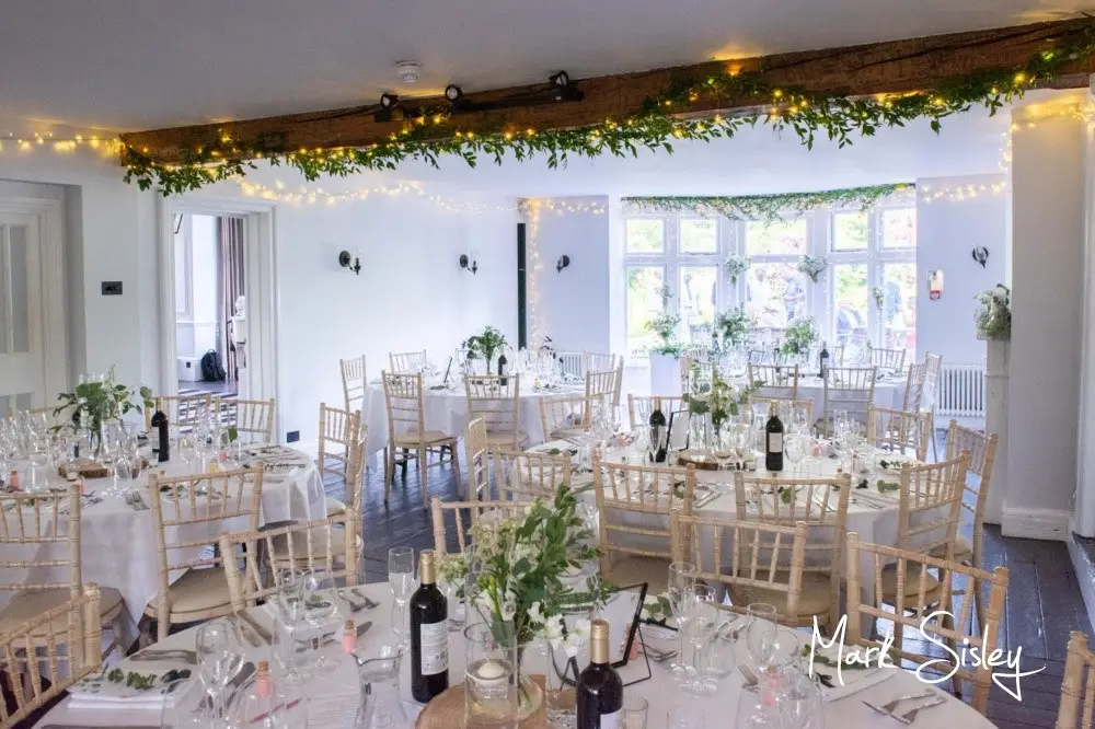 The Olde Bell Hurley function room dressed for a wedding with fairy lights and greenery.