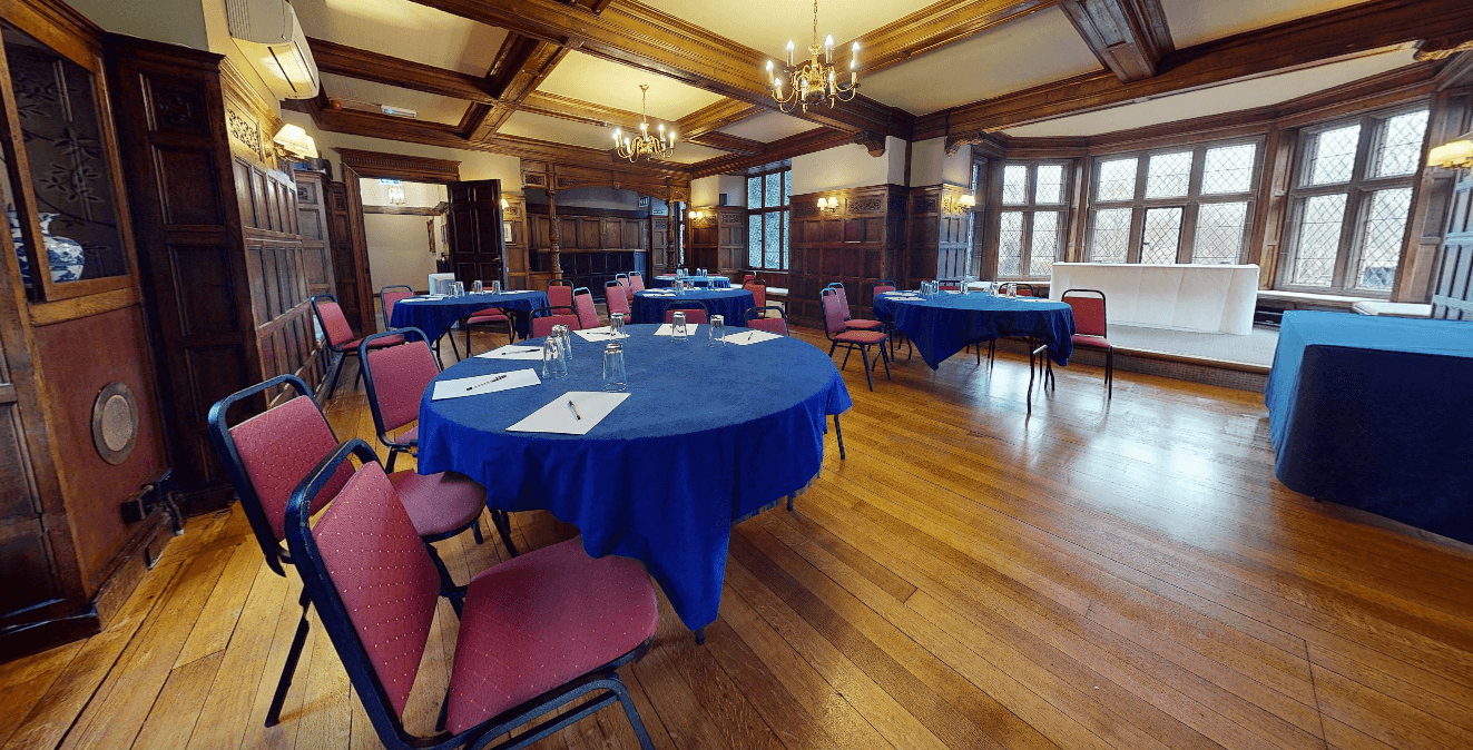 Panelled function room with round tables set for a meeting at Rothley Court Hotel.