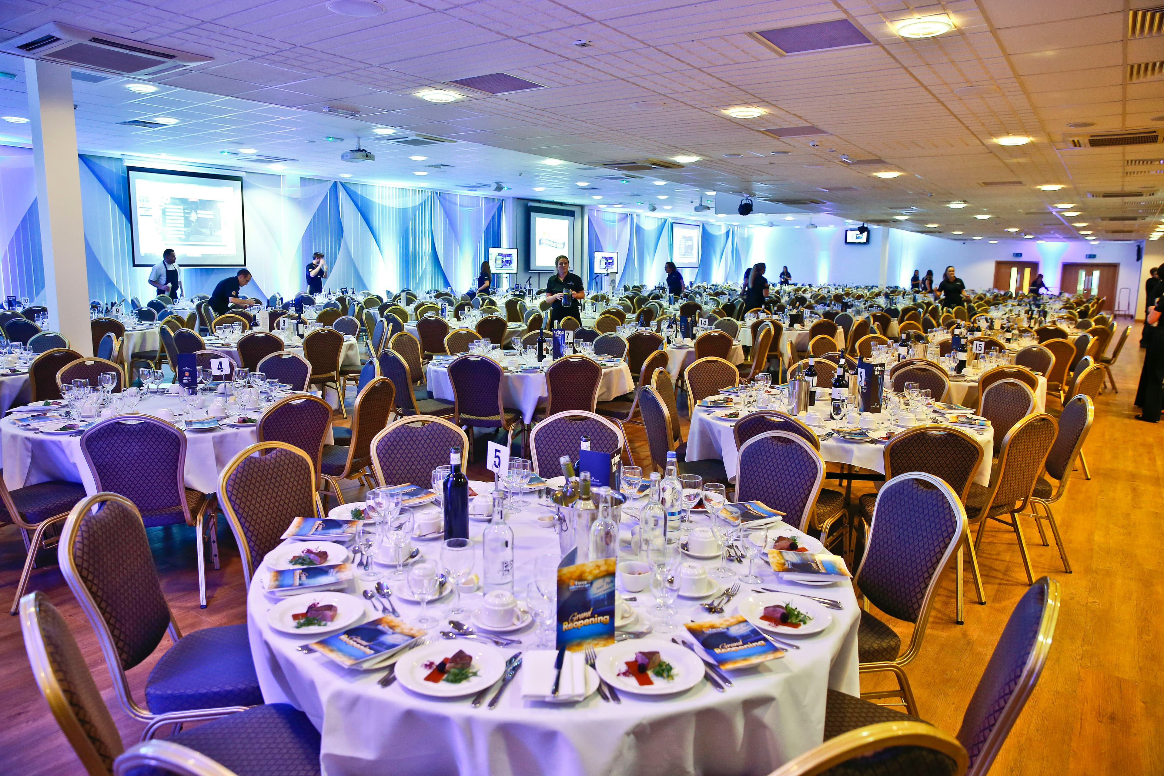 Exeter Suite - Large banqueting suite laid for a formal dinner with numbered round tables