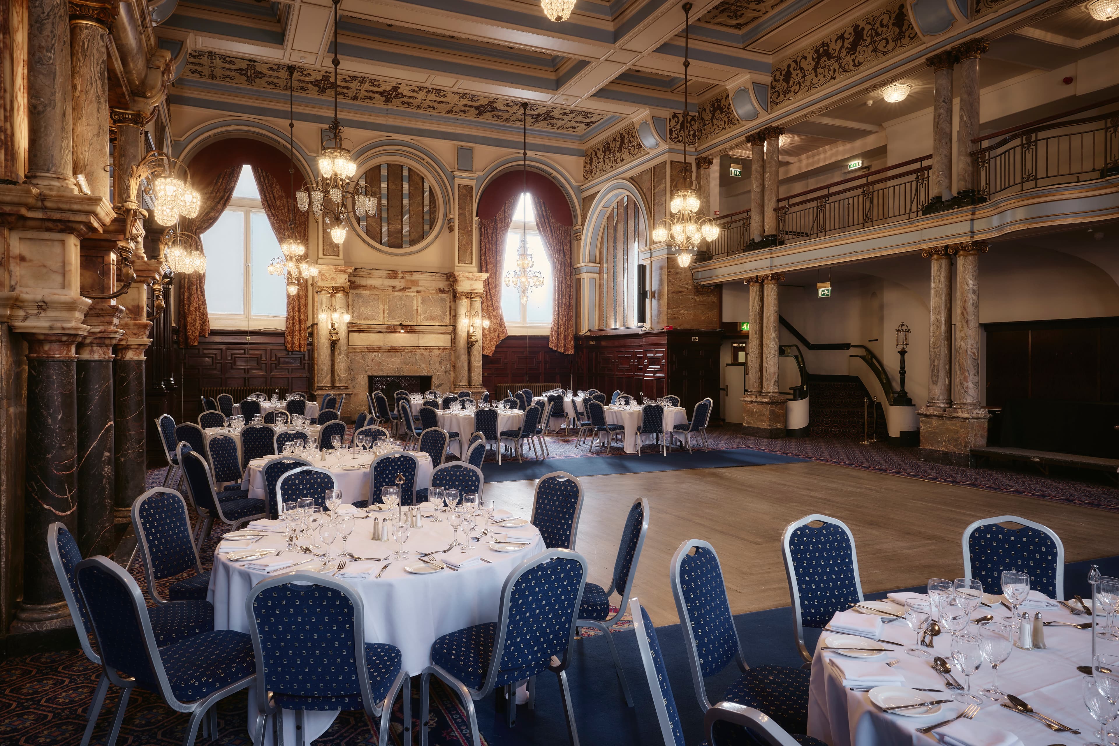 Grand ballroom at The Grand Hotel Leicester laid for a formal dinner with round tables.