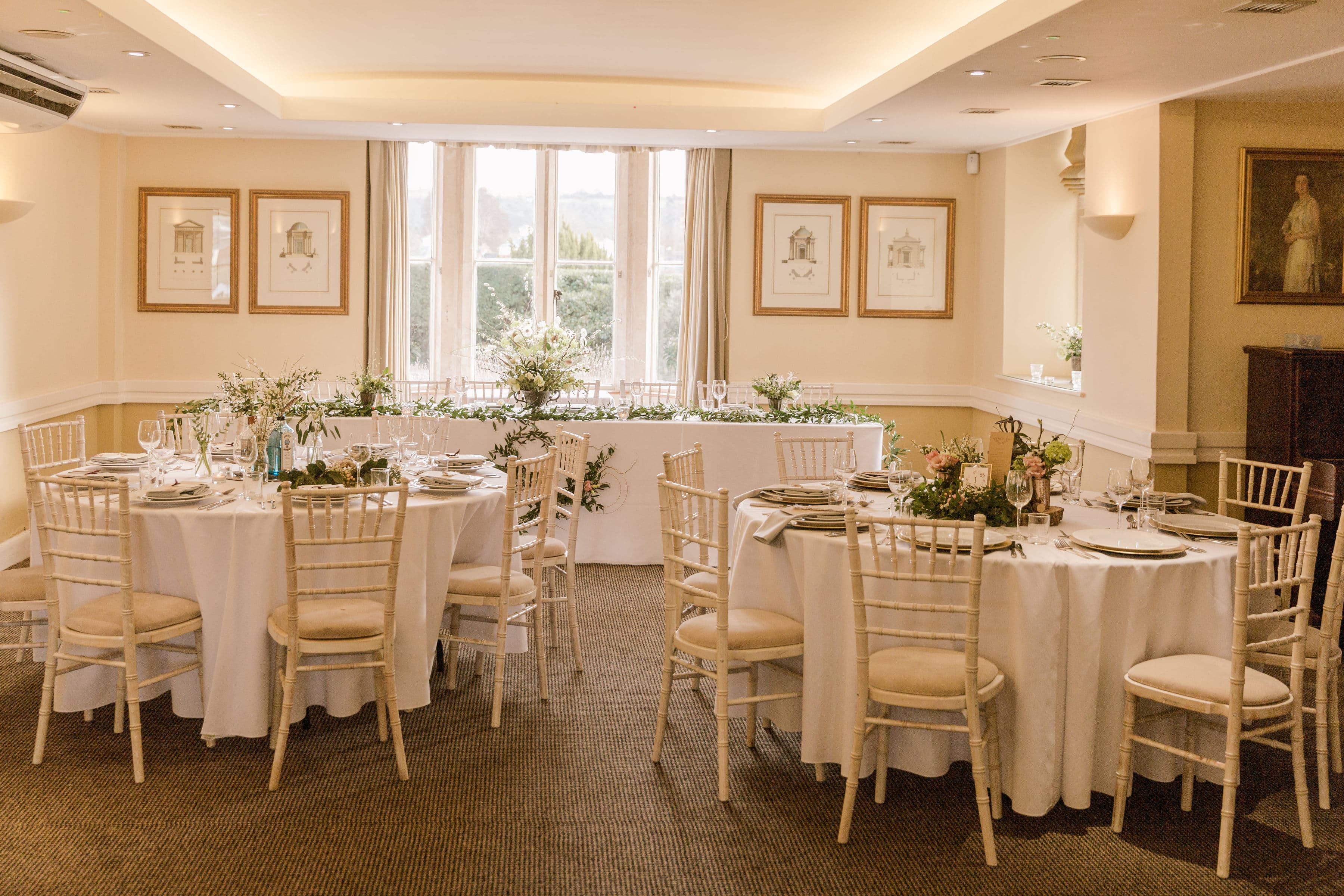 The Hill's private dining room laid for a wedding breakfast with chiavari chairs.