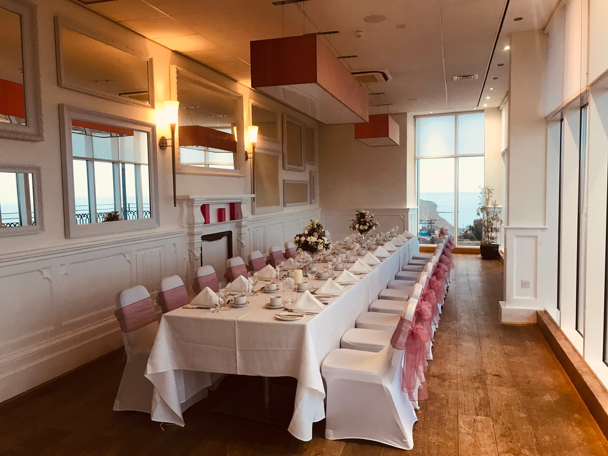 Banqueting room laid for a formal event with sea views at The Palace Hotel.