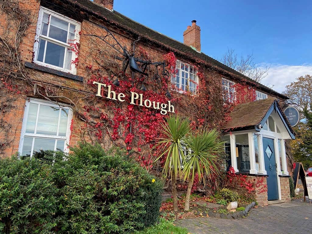 The red ivy-covered brick exterior of The Plough pub in Nottingham.