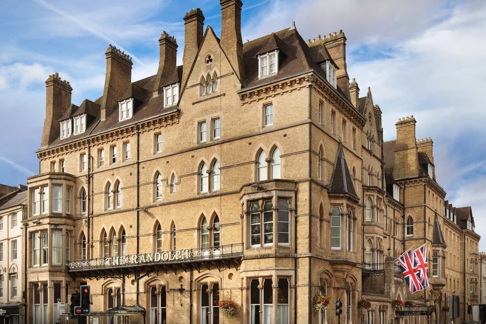 The Victorian Gothic exterior of The Randolph Hotel in Oxford with a Union flag flying.