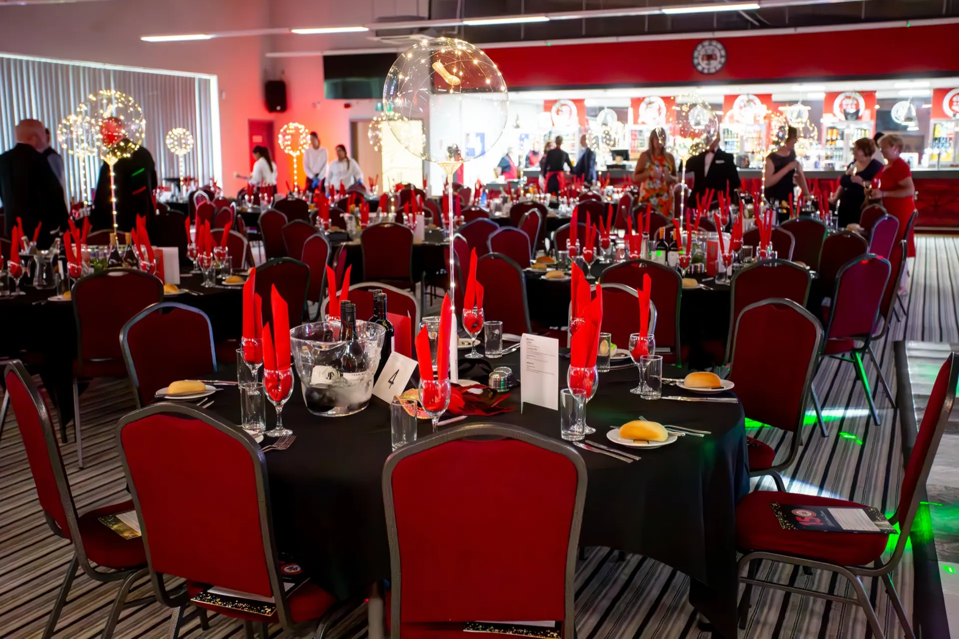 The Reddings Suite function room set for a gala dinner with red and black décor.