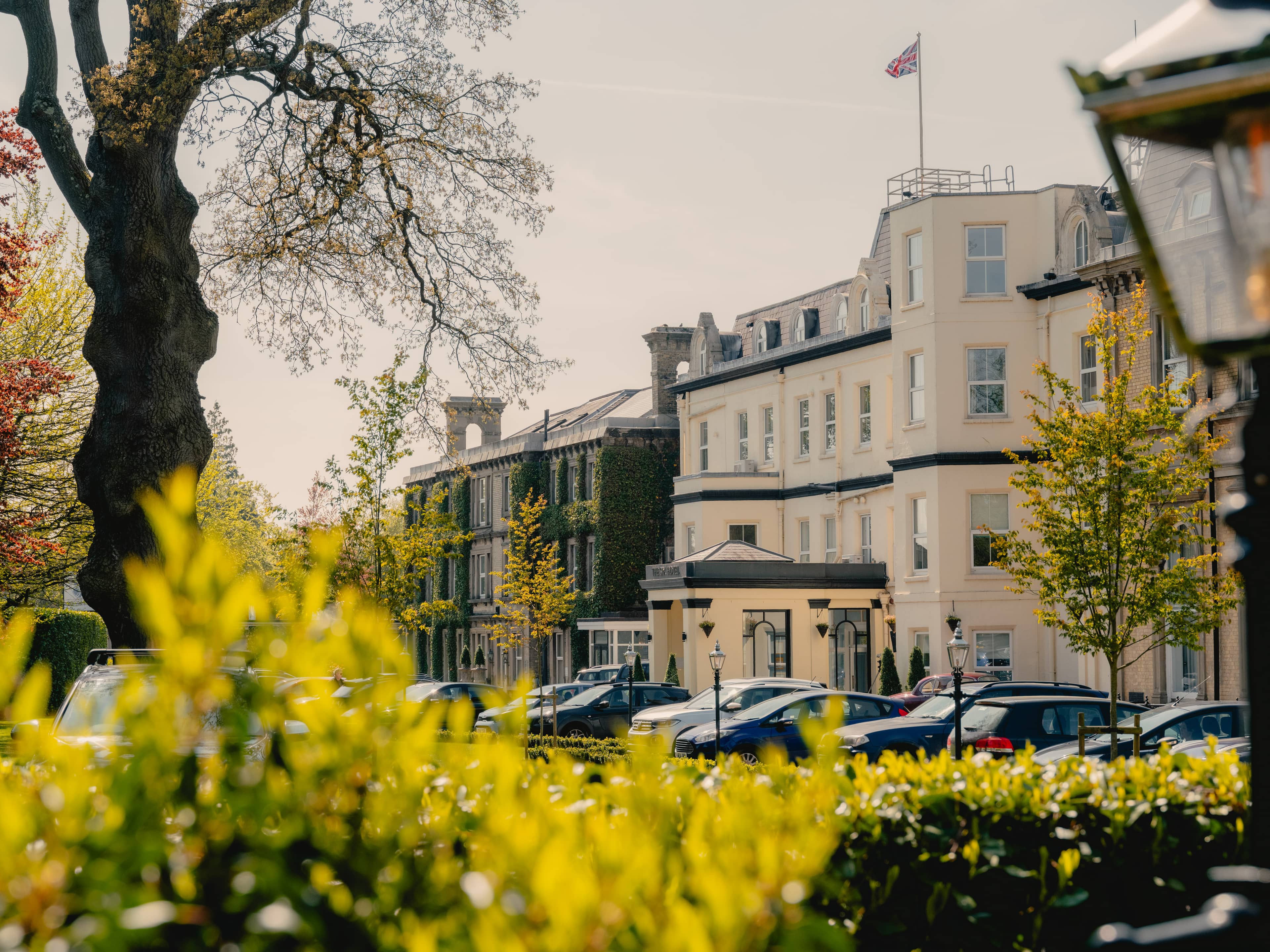 The Spa Hotel exterior in spring with a Union Jack flag flying above the building.
